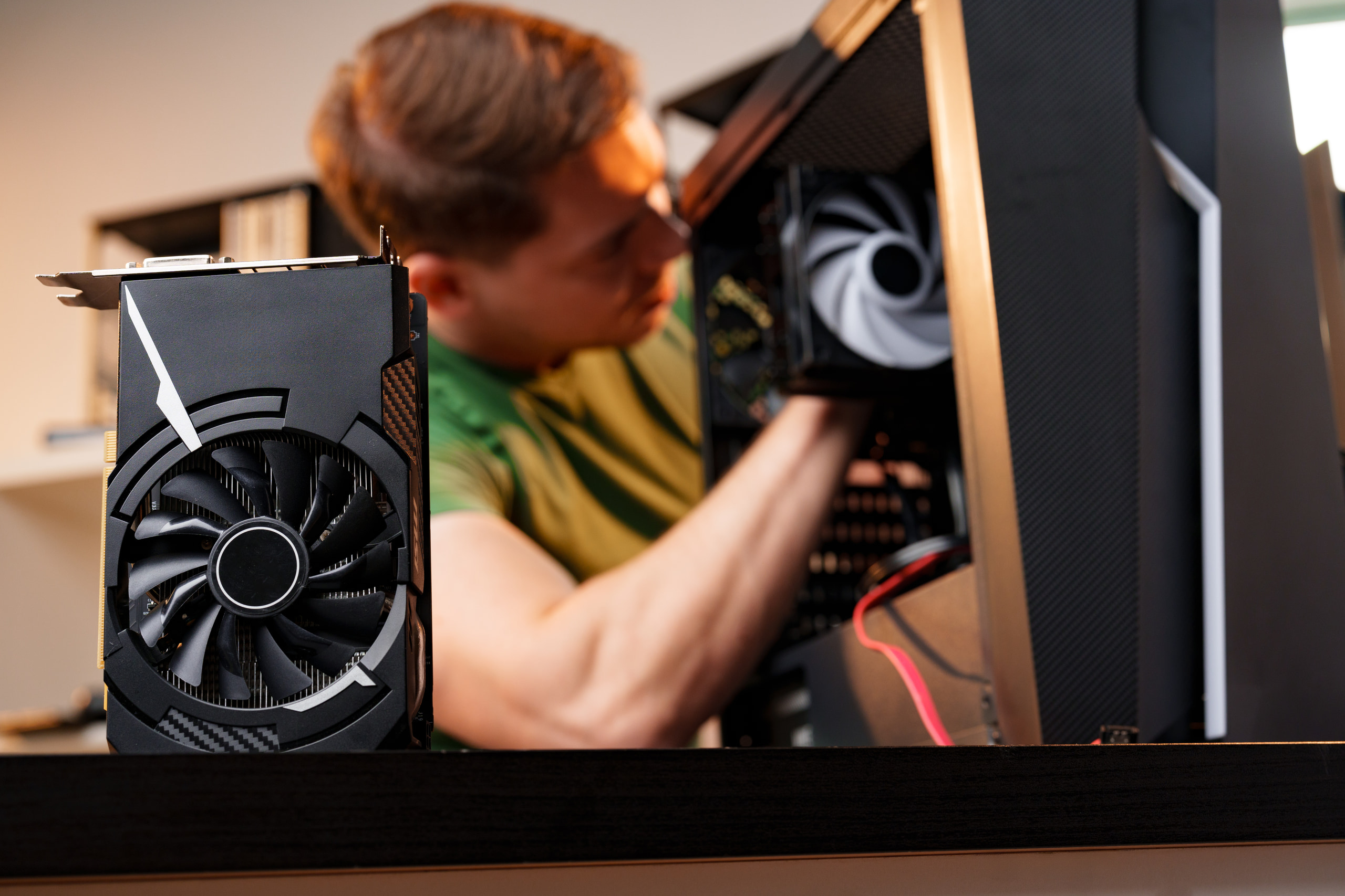 Technician fitting a graphics card into a modern mid-tower build